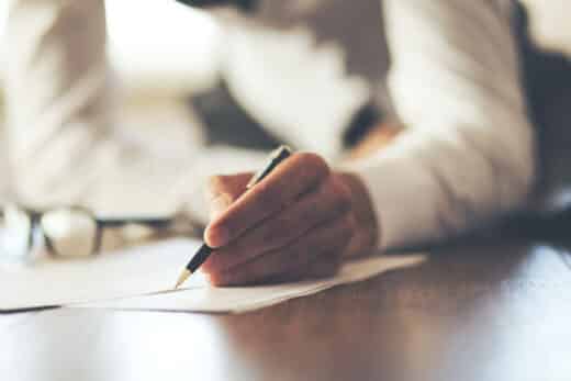 homme inscrit ses dernière volontes sur un contrat obsèques